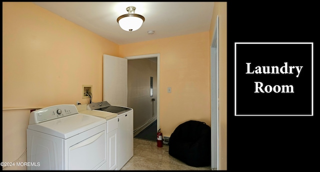 washroom featuring light tile patterned flooring and washing machine and clothes dryer