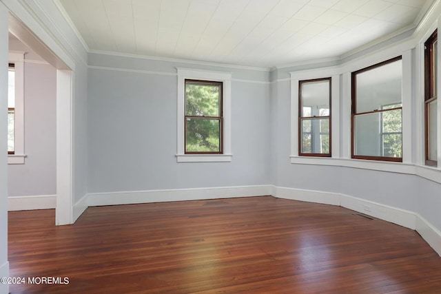 unfurnished room featuring crown molding and dark hardwood / wood-style flooring