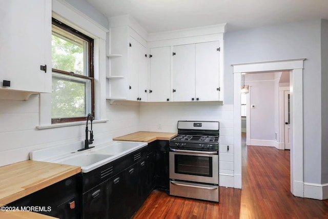 kitchen featuring sink, dark hardwood / wood-style floors, stainless steel range with gas cooktop, and white cabinetry