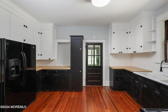 kitchen featuring dark hardwood / wood-style floors, backsplash, black fridge with ice dispenser, and white cabinets