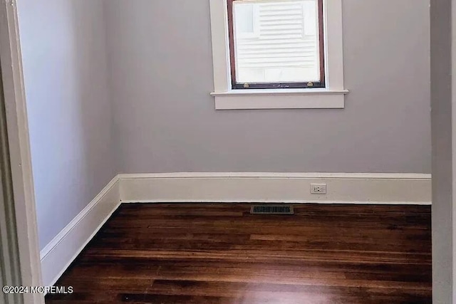 spare room with dark hardwood / wood-style flooring