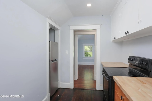 kitchen with electric range, stainless steel fridge, dark hardwood / wood-style flooring, and white cabinetry