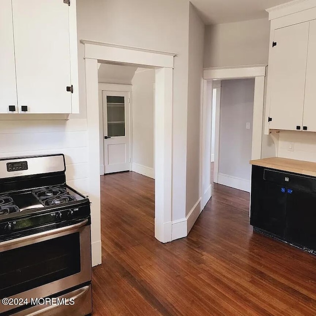 kitchen featuring white cabinets, dark wood-type flooring, and stainless steel range with gas cooktop