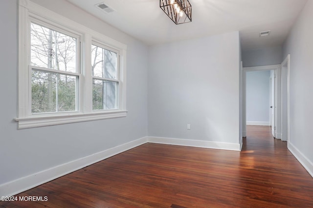 unfurnished room with dark hardwood / wood-style floors