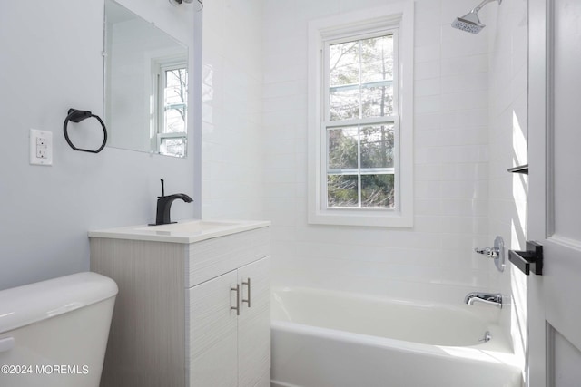 full bathroom featuring tiled shower / bath combo, vanity, and toilet