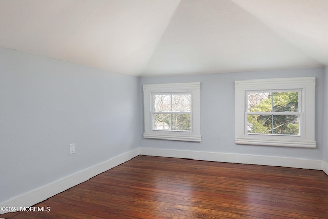 unfurnished room with lofted ceiling and dark hardwood / wood-style floors