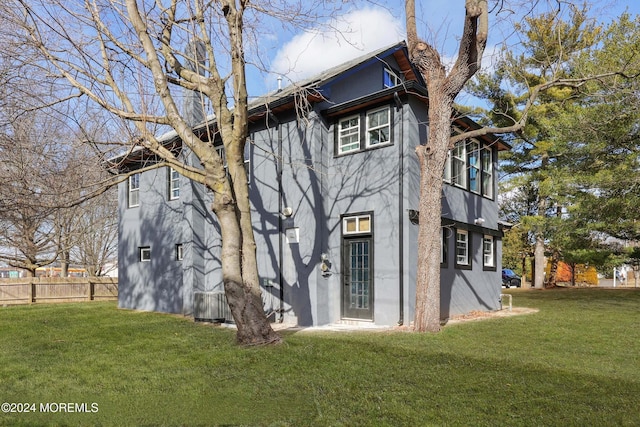 rear view of property with a lawn