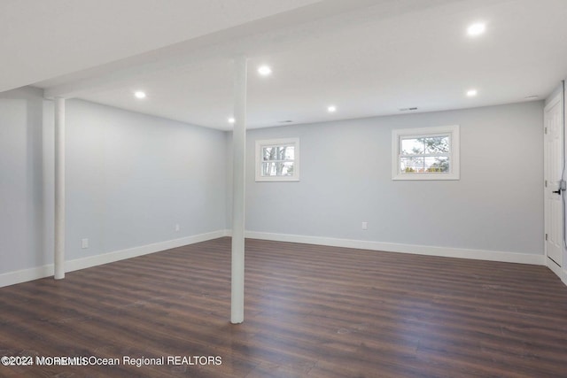 basement with dark hardwood / wood-style floors