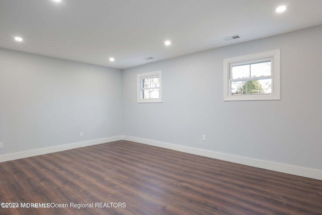 spare room featuring dark hardwood / wood-style flooring