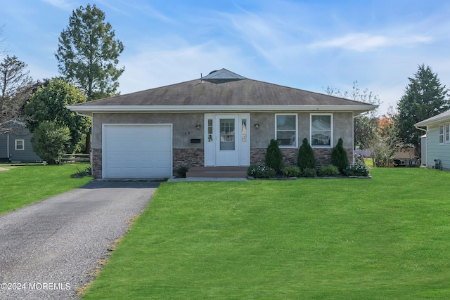 single story home with a garage and a front lawn