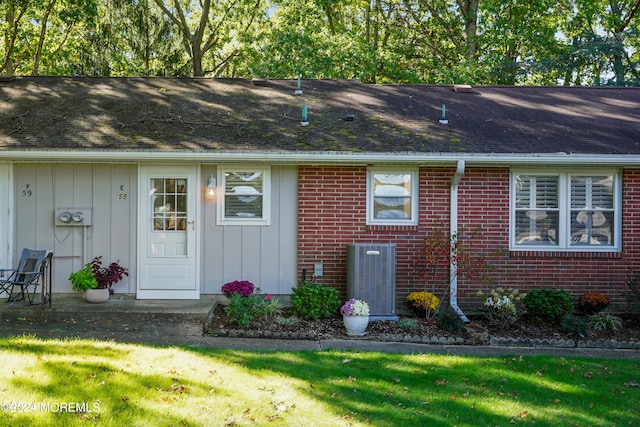 exterior space with a yard and cooling unit