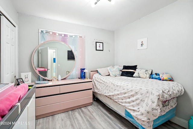 bedroom featuring a closet and light wood-type flooring