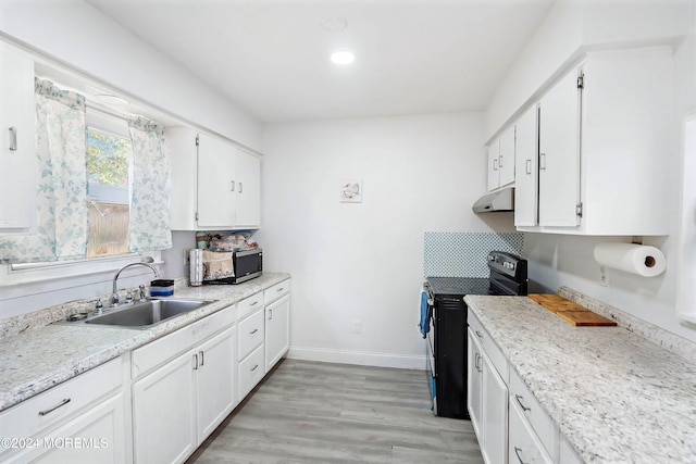 kitchen featuring black electric range oven and white cabinets