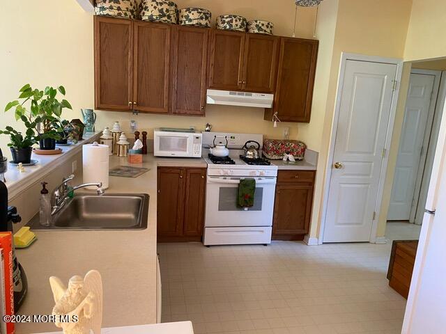 kitchen featuring sink and white appliances