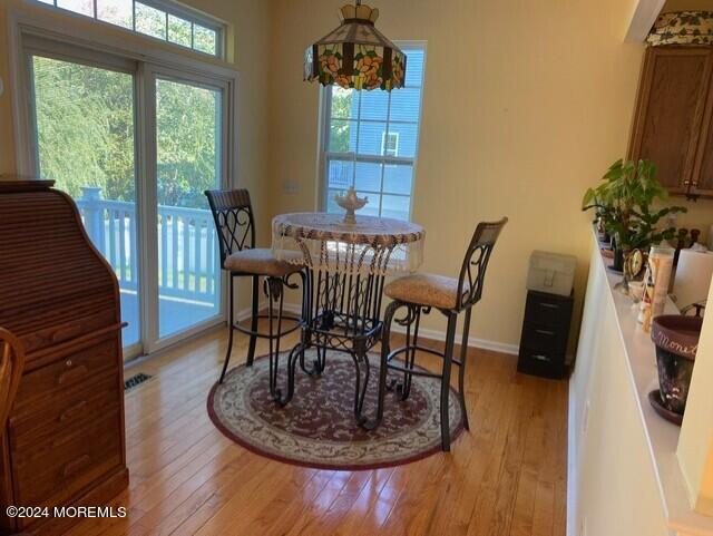 dining space with light hardwood / wood-style floors