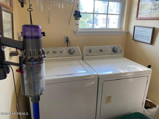 clothes washing area featuring washing machine and clothes dryer