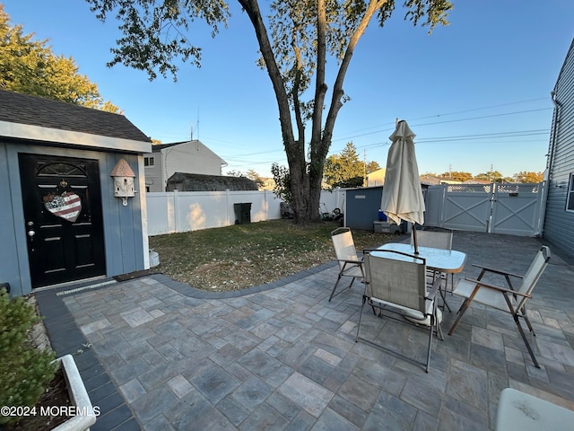 view of patio featuring a storage shed