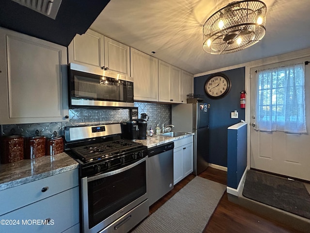 kitchen featuring white cabinetry, light stone counters, and appliances with stainless steel finishes