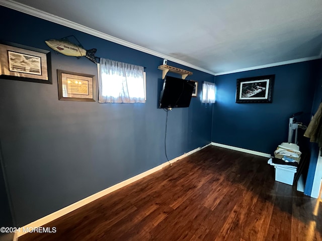 empty room with ornamental molding and dark hardwood / wood-style flooring