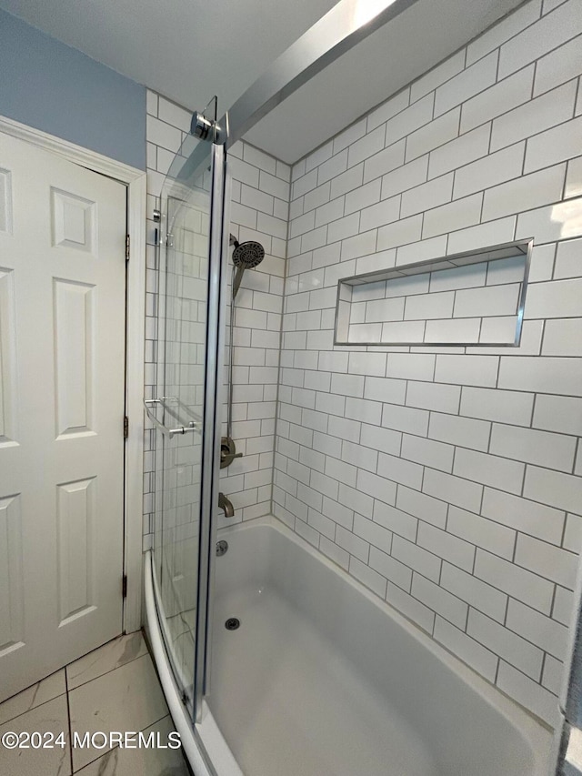 bathroom with tile patterned floors and enclosed tub / shower combo