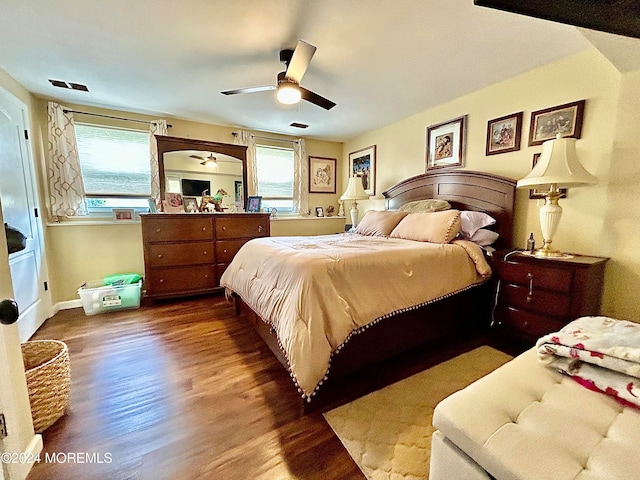 bedroom featuring multiple windows, wood-type flooring, and ceiling fan