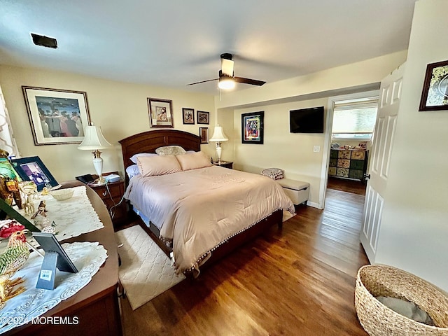 bedroom with dark hardwood / wood-style flooring and ceiling fan