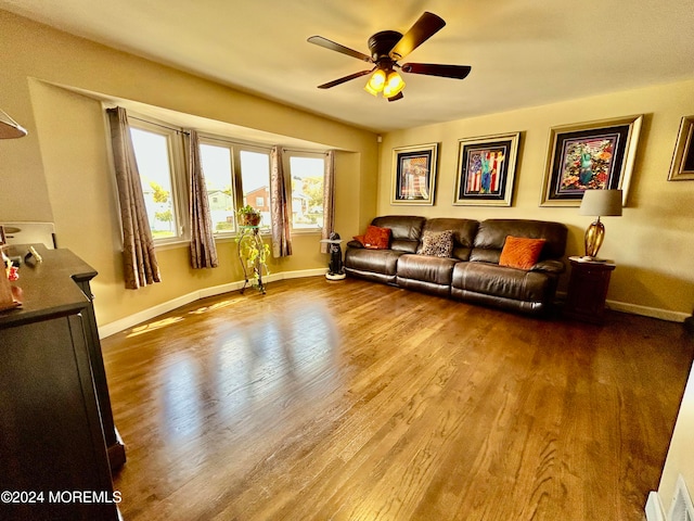 living room with wood-type flooring and ceiling fan