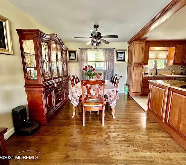 dining room with ceiling fan, wood-type flooring, and sink