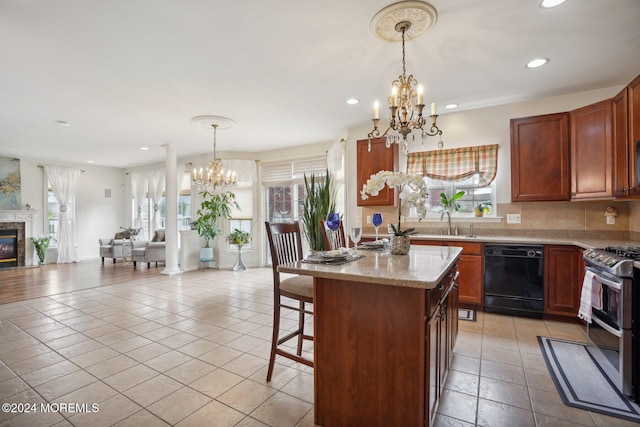 kitchen with a wealth of natural light, stainless steel range, ornate columns, and dishwasher