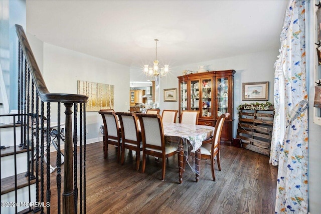 dining room featuring dark wood-type flooring and a chandelier