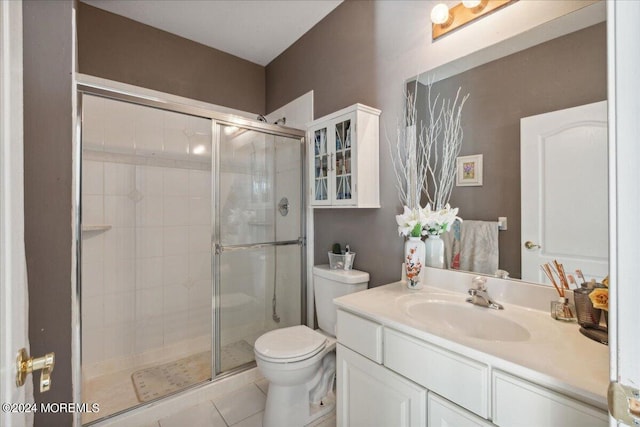 bathroom featuring vanity, tile patterned floors, toilet, and walk in shower