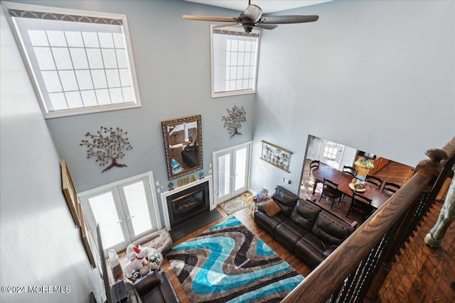 living room with a healthy amount of sunlight, a high ceiling, and ceiling fan