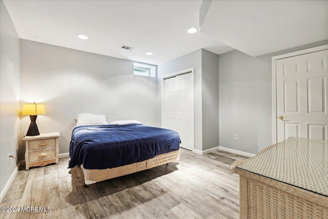 bedroom with light hardwood / wood-style flooring and a closet