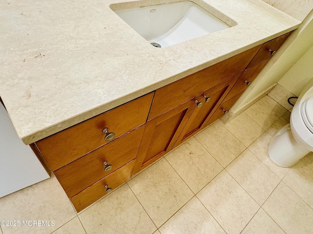 bathroom with vanity, tile patterned floors, and toilet