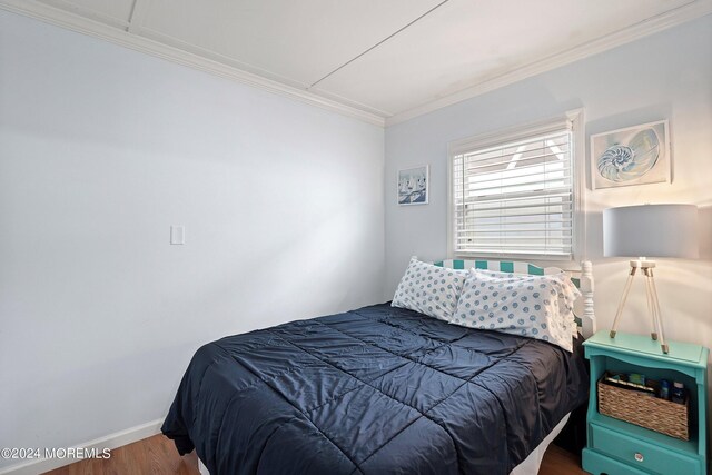 304 Bay Blvd, Seaside Heights, NJ 08751 - bedroom featuring ornamental molding, wood finished floors, and baseboards