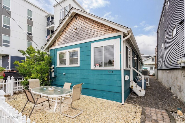 304 Bay Blvd, Seaside Heights, NJ 08751 - rear view of property featuring fence and outdoor dining space