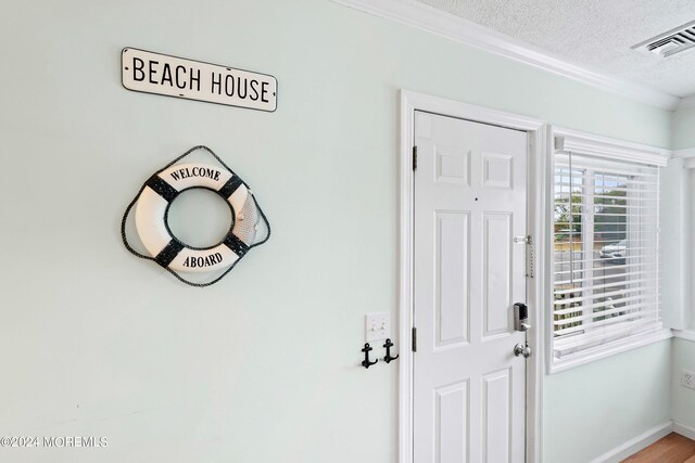 304 Bay Blvd, Seaside Heights, NJ 08751 - foyer with a textured ceiling, crown molding, and baseboards