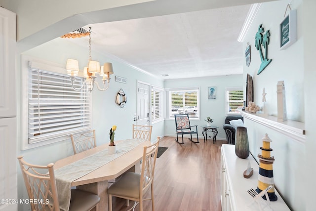 304 Bay Blvd, Seaside Heights, NJ 08751 - dining space with wood finished floors, a chandelier, crown molding, and baseboards