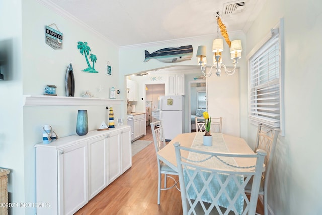 304 Bay Blvd, Seaside Heights, NJ 08751 - dining room with a chandelier, crown molding, light wood-style flooring, and healthy amount of natural light