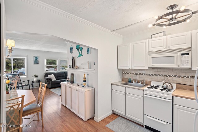 304 Bay Blvd, Seaside Heights, NJ 08751 - kitchen with white appliances, a sink, light wood-type flooring, backsplash, and light countertops