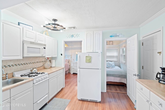 304 Bay Blvd, Seaside Heights, NJ 08751 - kitchen featuring white appliances, crown molding, a textured ceiling, decorative backsplash, and a sink
