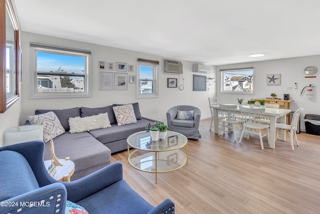 living room featuring light hardwood / wood-style floors and a wall mounted AC