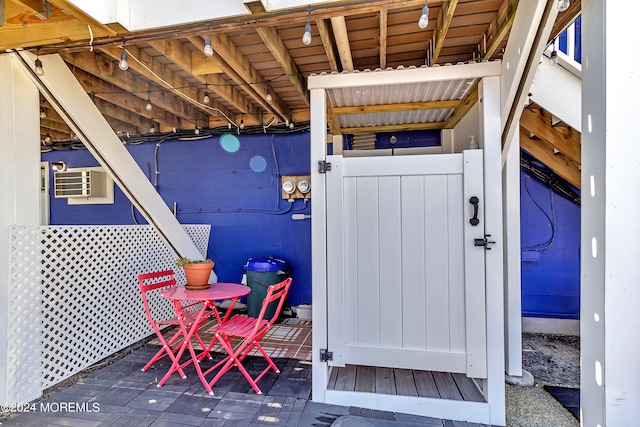 wooden deck with a wall mounted air conditioner