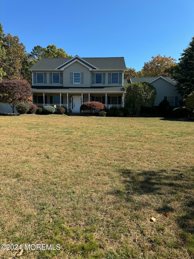 view of front of property with a front yard and covered porch