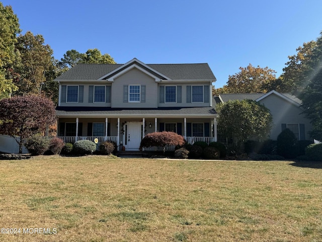 view of front facade featuring covered porch and a front yard