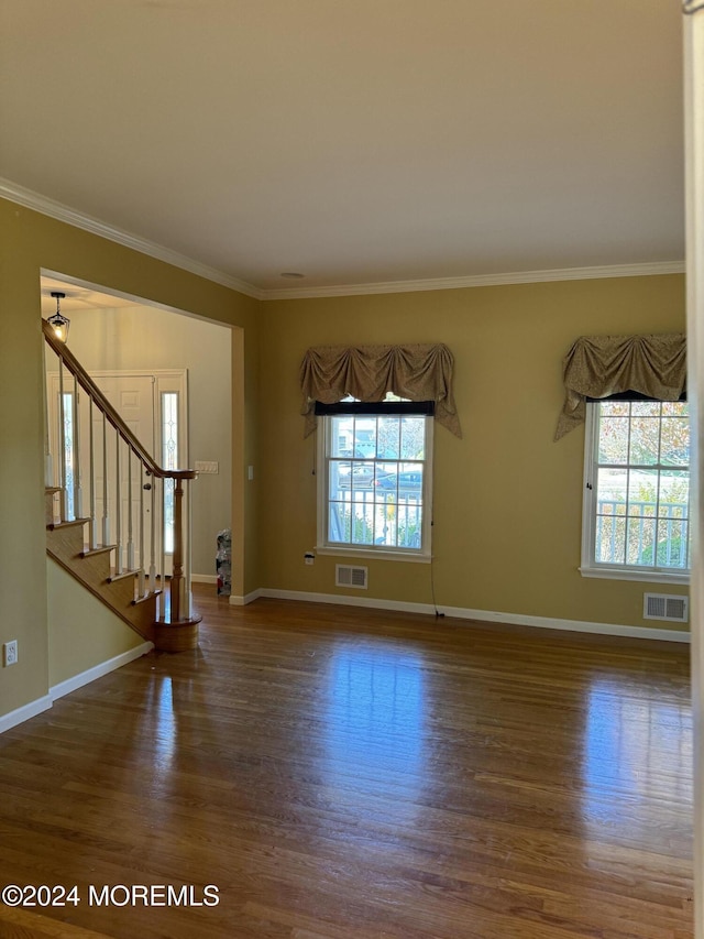 interior space featuring ornamental molding and dark hardwood / wood-style floors