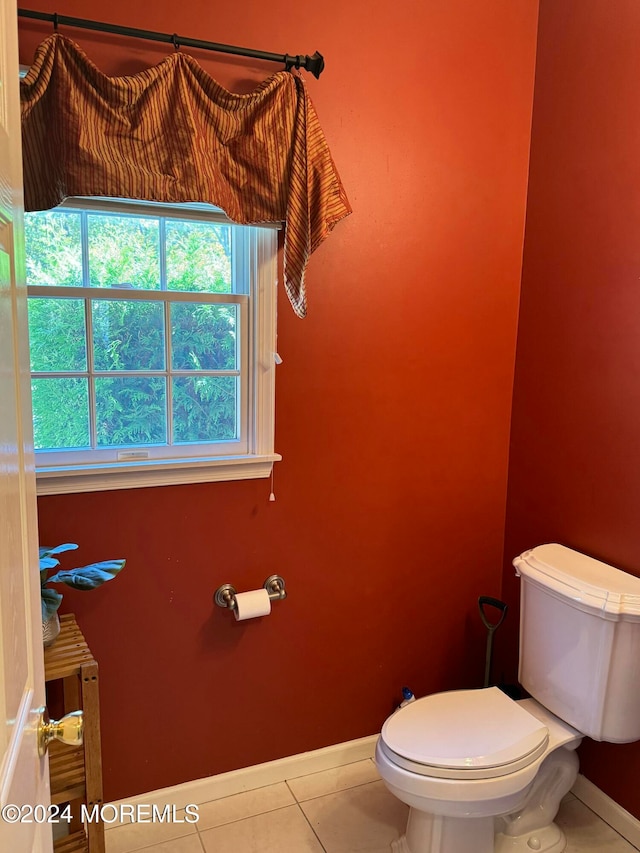 bathroom with toilet and tile patterned floors