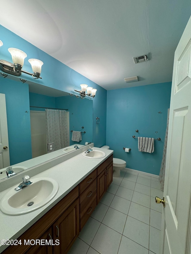 bathroom featuring vanity, a shower with curtain, toilet, and tile patterned floors