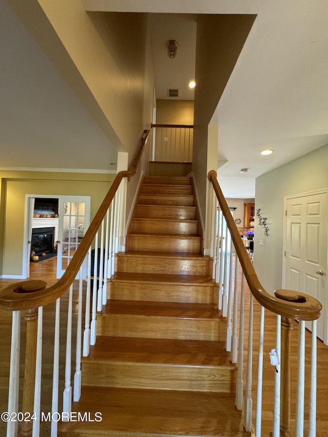 stairs featuring hardwood / wood-style floors