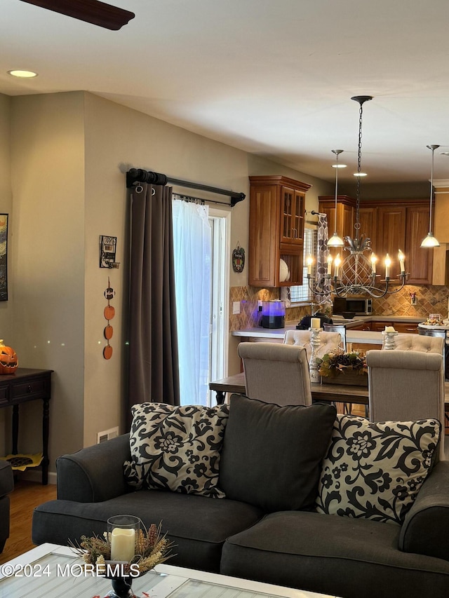 living room with a notable chandelier and wood-type flooring